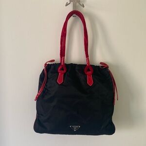 Prada bag in nylon fabric with red calfskin and velvet details.